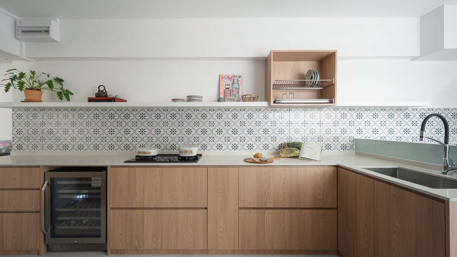 L-shaped kitchen with light oak cabinets, white quartz countertop, Peranakan tile backsplash, wine chiller and open floating shelf